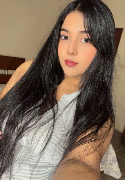 Woman with long dark hair smiling at the camera